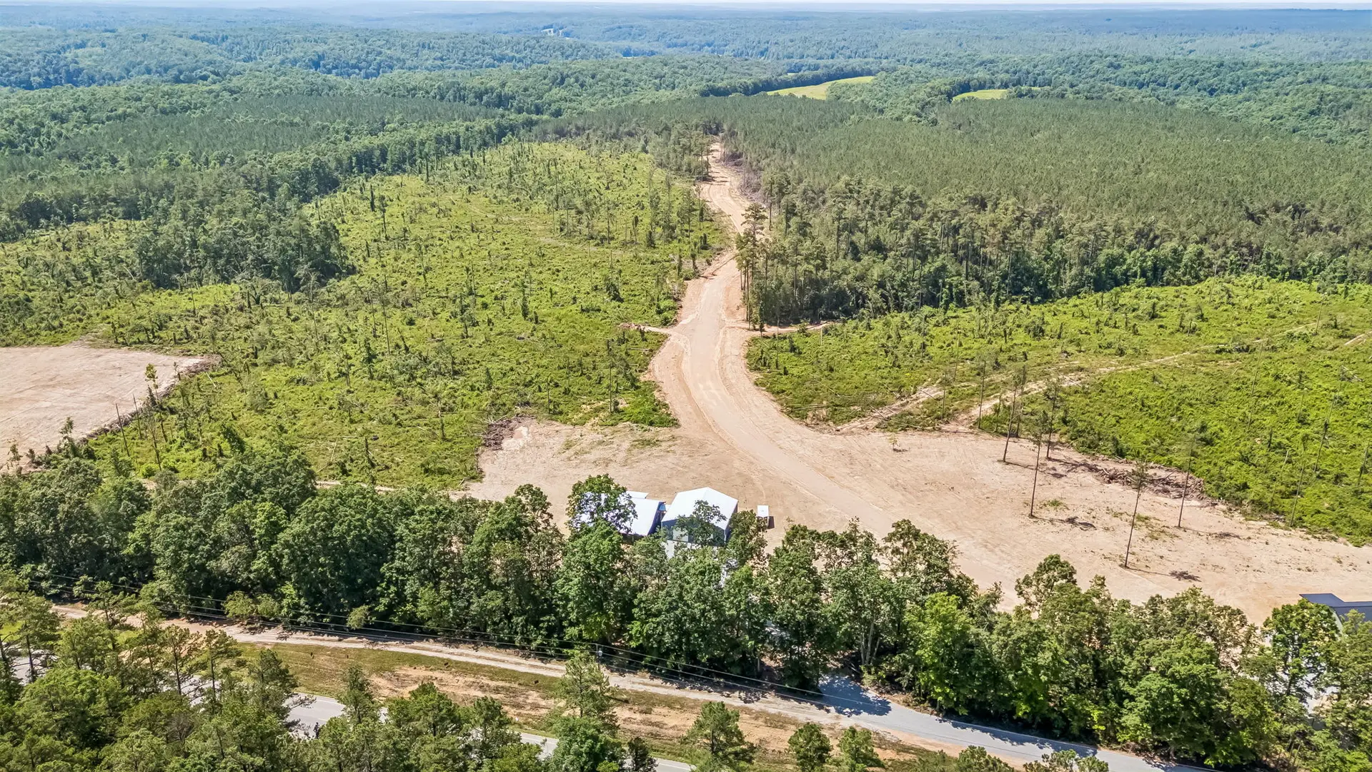 Aerial approach view at 1855 Linden Hwy, a barndominium in Hohenwald, Tennessee